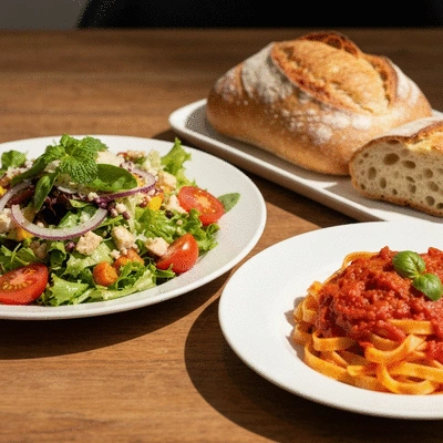 Gourmet Italian share plates with fresh pasta and salads on a rustic table
