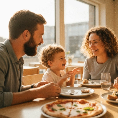 Family enjoying a meal at a bright modern restaurant with kids laughing